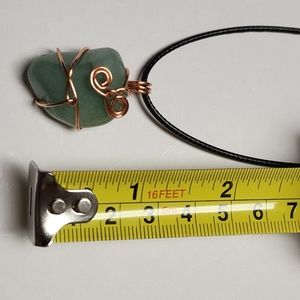 Handmade wire wrap stone pendant with cord.